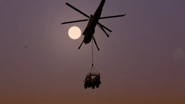 The sky-crane helicopter lifts the rig away against a low sun.